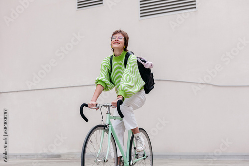 Cheerful woman riding bicycle on street photo