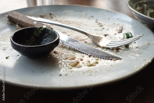 Empty plate after eating on table 
