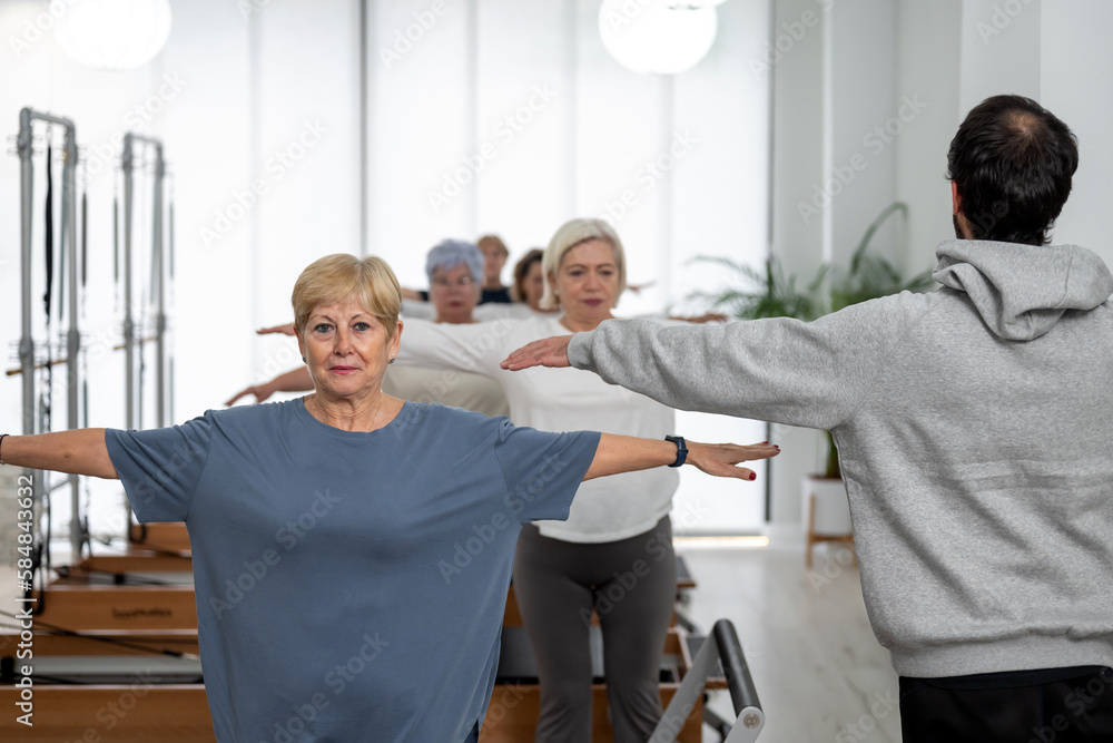 Senior women during group pilates training Senior women during group pilates training