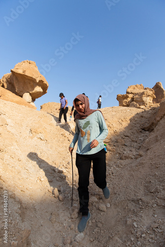 Muslim Woman Hiking In Saudi Desert photo