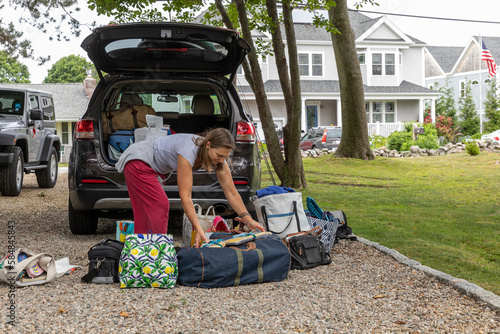 Packing gear luggage in car for family road trip  photo