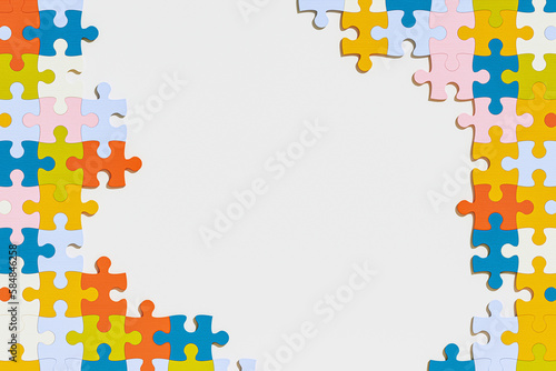 Blank space center and colorful jigsaw puzzle pieces form the frame photo