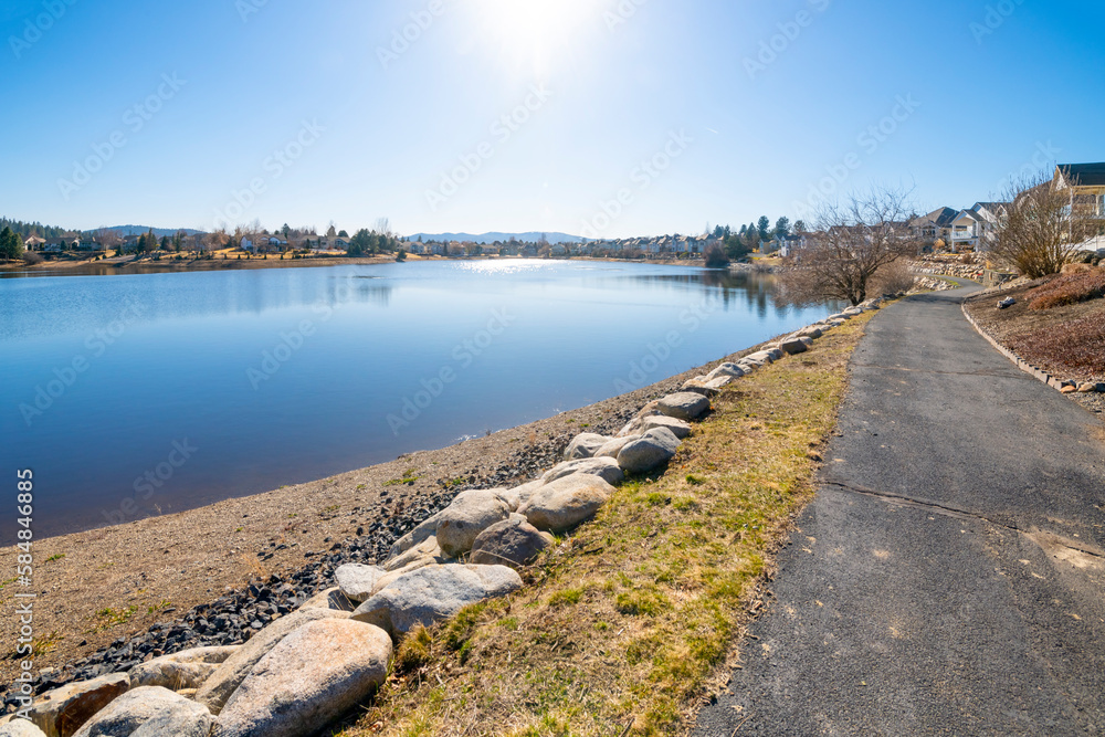 A walking trail for luxury waterfront homes at Shelley Lake, a natural lake in the suburban city of Spokane Valley, Washington, USA.