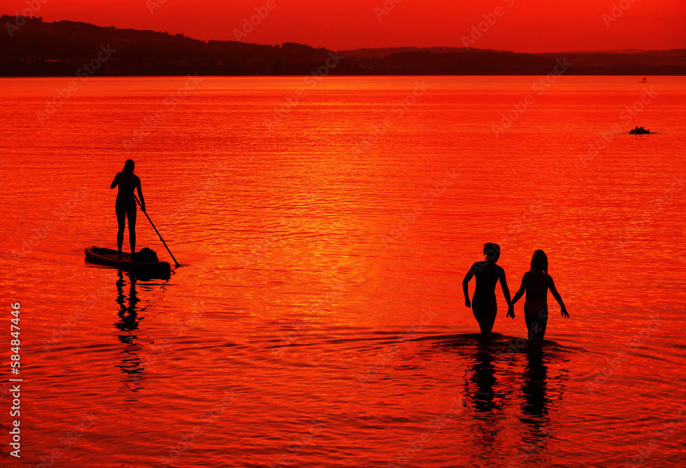 Tourists enjoying the sunset at Sempach lake in Switzerland, Europe	