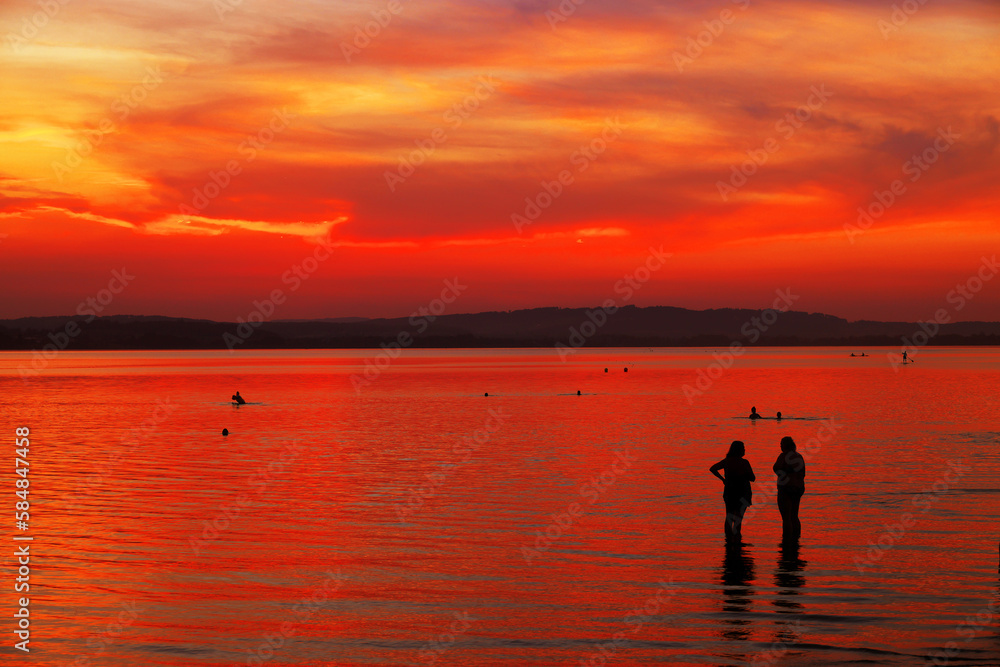 Tourists enjoying the sunset at Sempach lake in Switzerland, Europe