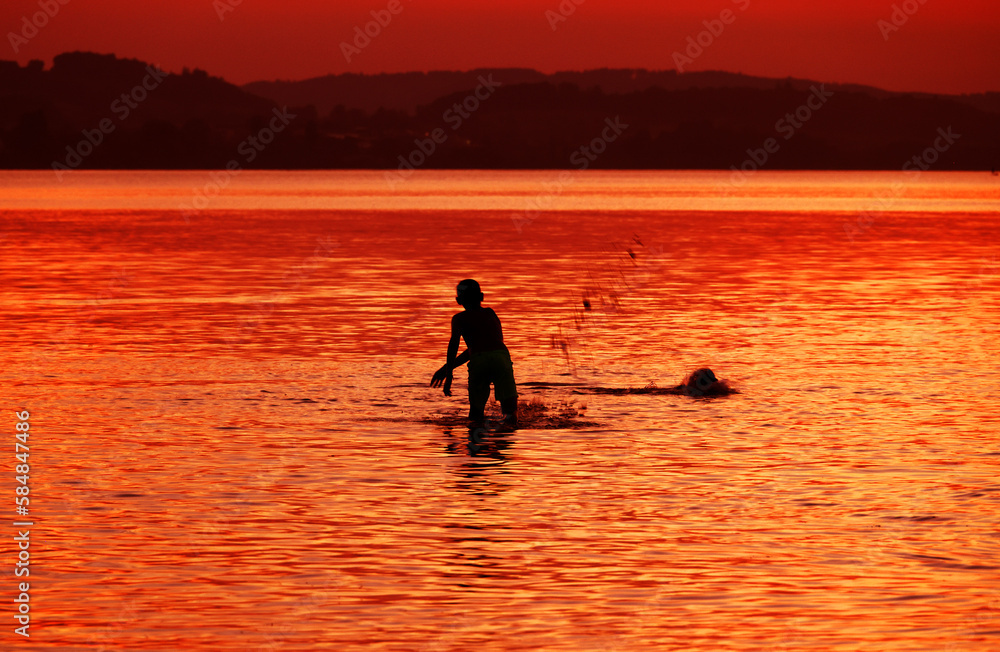 Tourists enjoying the sunset at Sempach lake in Switzerland, Europe