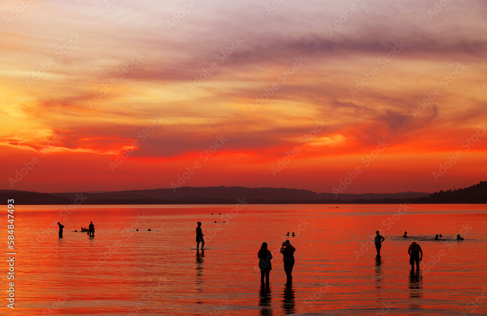 Tourists enjoying the sunset at Sempach lake in Switzerland, Europe