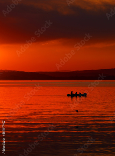 Tourists enjoying the sunset at Sempach lake in Switzerland, Europe
