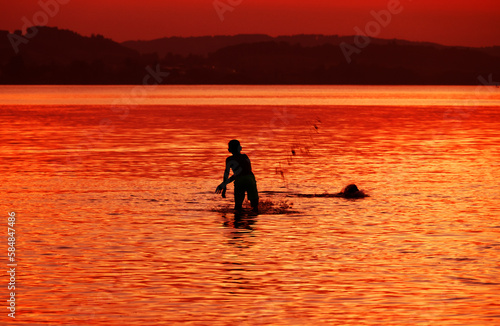 Tourists enjoying the sunset at Sempach lake in Switzerland  Europe