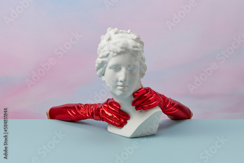 Aphrodite bust with hands in red gauntlets. photo