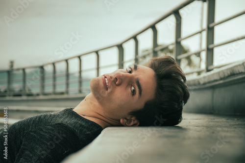 portrait of handsome guy lying down 