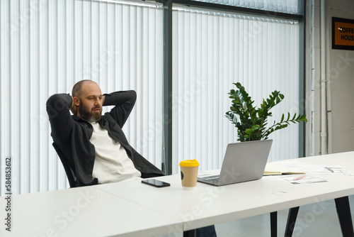 Wallpaper Mural Male employee watching video on laptop in office
 Torontodigital.ca
