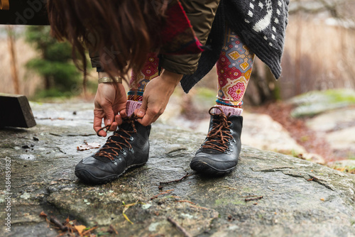 Close up of a unrecognizable person tying cordons in a hiking boots photo