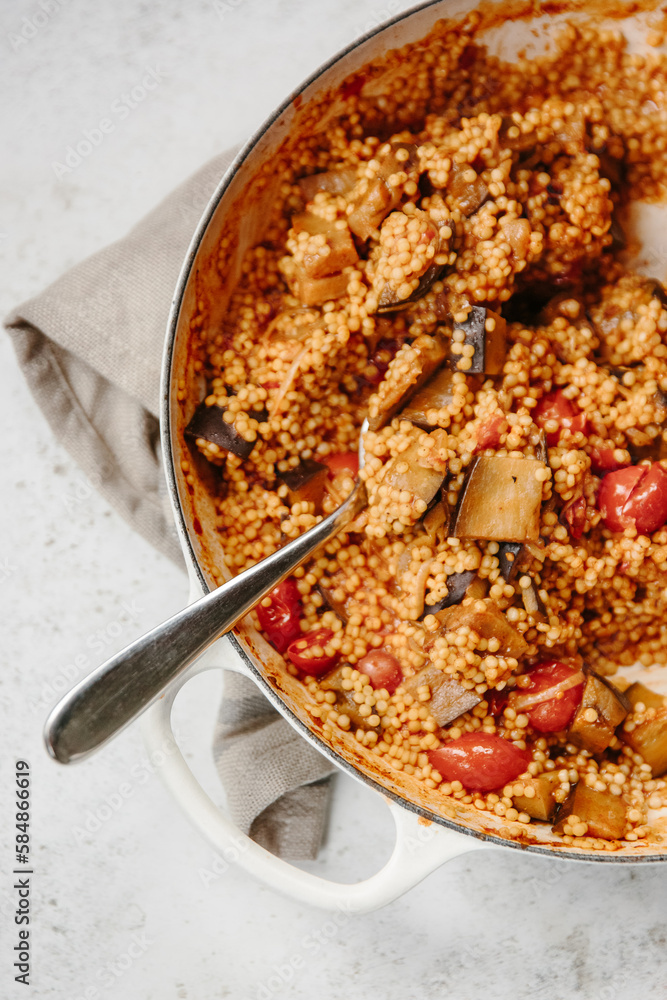 A dish of pearl couscous with tomatoes and aubergine. A dish of pearl couscous with tomatoes and aubergine.