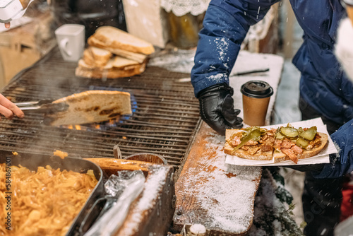 Local street food at the Christmas market in Europe in snowy weather photo