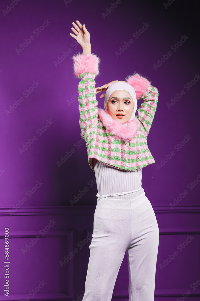 Beautiful female model wearing modern hijab, an Asian traditionals for Muslim woman isolated over studio background. Stylish Muslim female hijab fashion lifestyle portraiture concept.