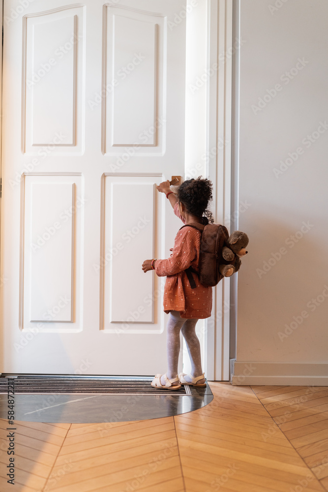 Anonymous Little Girl With Backpack Going Out The Door Anonymous Little Girl With Backpack Going Out The Door