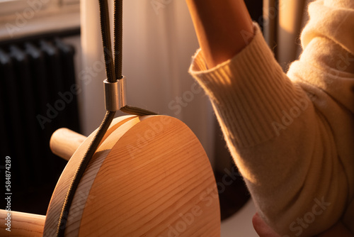 Close-Up of Carpenter's Hand Holding Wooden Stool