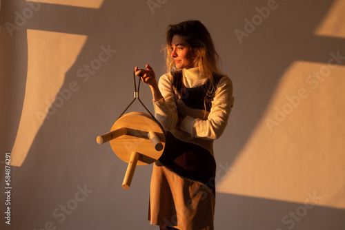 Female Designer Holding Designed Wooden Stool 