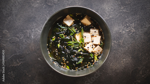 Asian food. Soup with seaweed, seafood and cheese in a stylish bowl. Restaurant service.