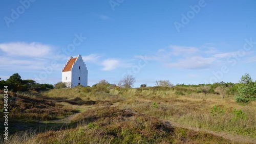 2022 - The Den Tilsandede Kirke (the sand-covered church) sits in the sun in Skagen, Denmark. photo