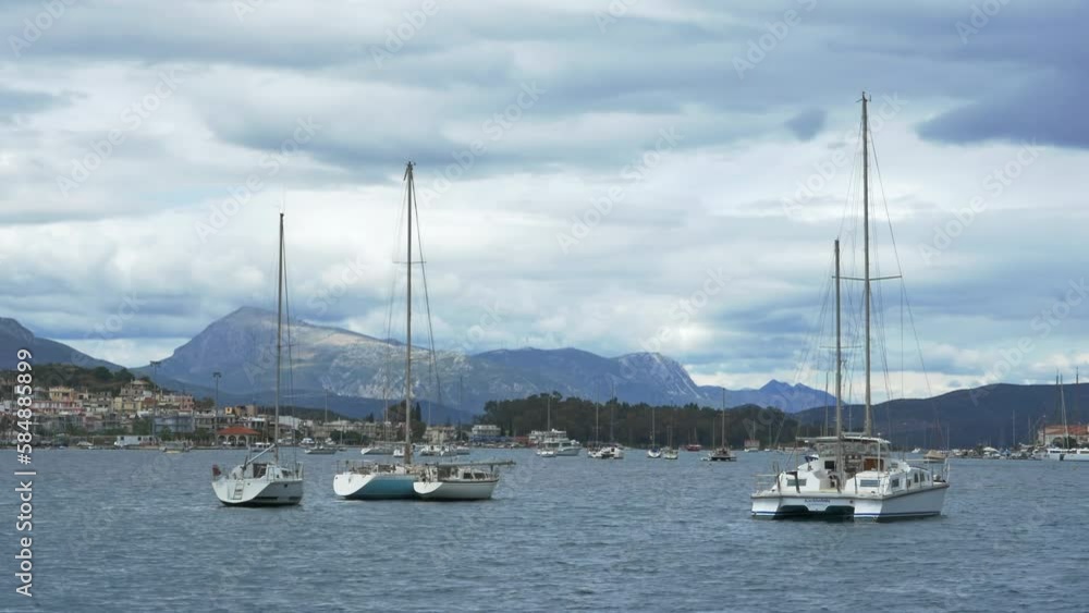 Panoramic view of the anchorage of white yachts in the sea bay off the coast of the city against the backdrop of high mountains. The concept of traveling on sailing yachts as an exciting hobby Panoramic view of the anchorage of white yachts in the sea bay off the coast of the city against the backdrop of high mountains. The concept of traveling on sailing yachts as an exciting hobby
