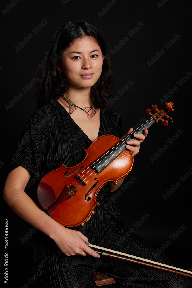 Female musician with violin looking at camera Female musician with violin looking at camera