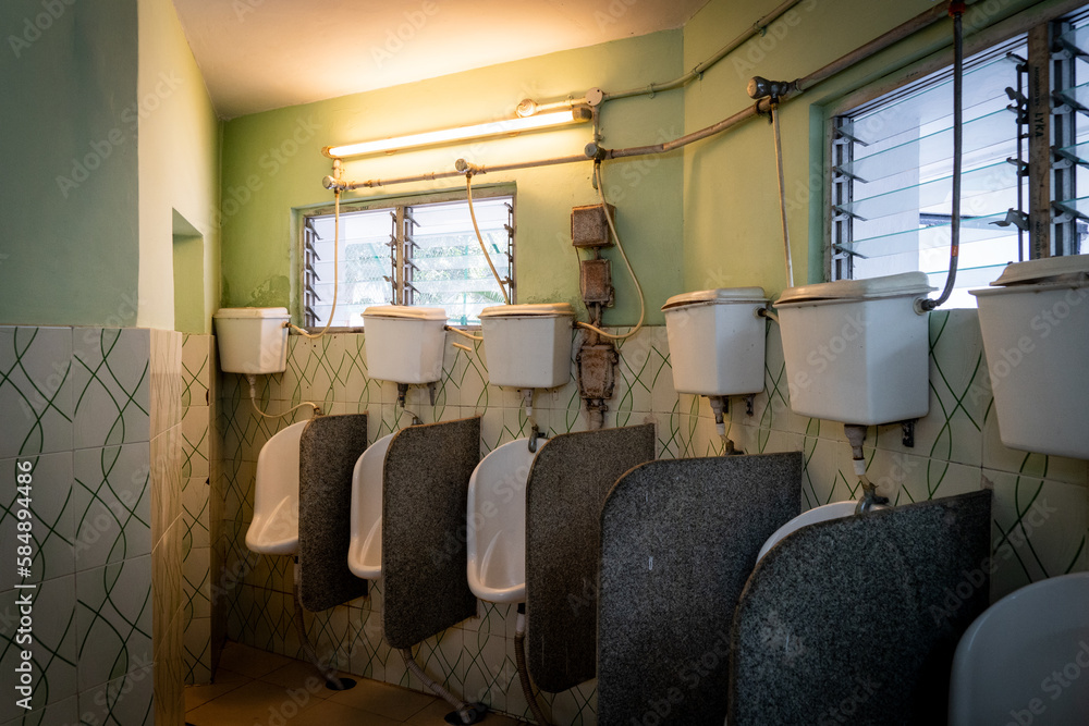 Old fashioned urinals at a public restroom in Kolkata, India Stock