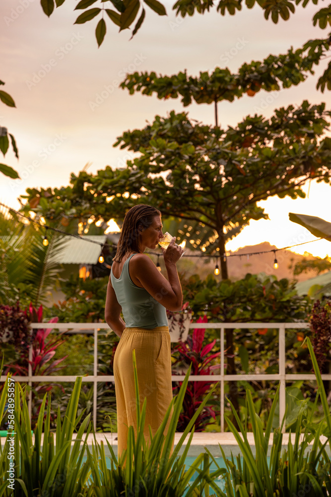 Elegant Woman portrait Luxury sips glass of wine at sunset on patio Elegant Woman portrait Luxury sips glass of wine at sunset on patio
