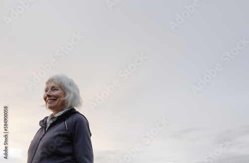 Active, healthy woman looking off into the distance outside.