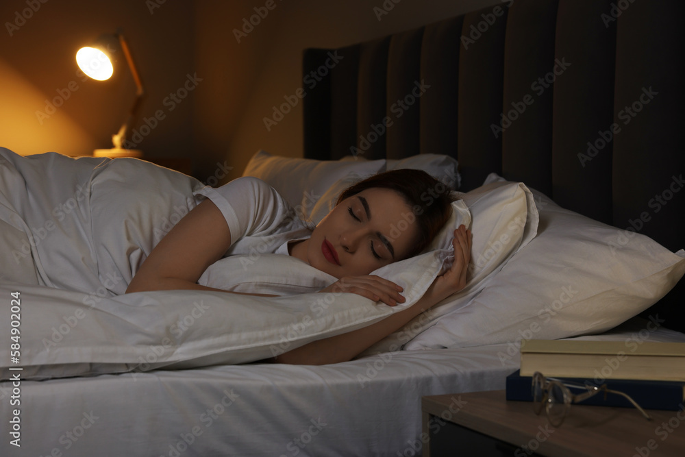 Beautiful young woman sleeping in bed at night Beautiful young woman sleeping in bed at night