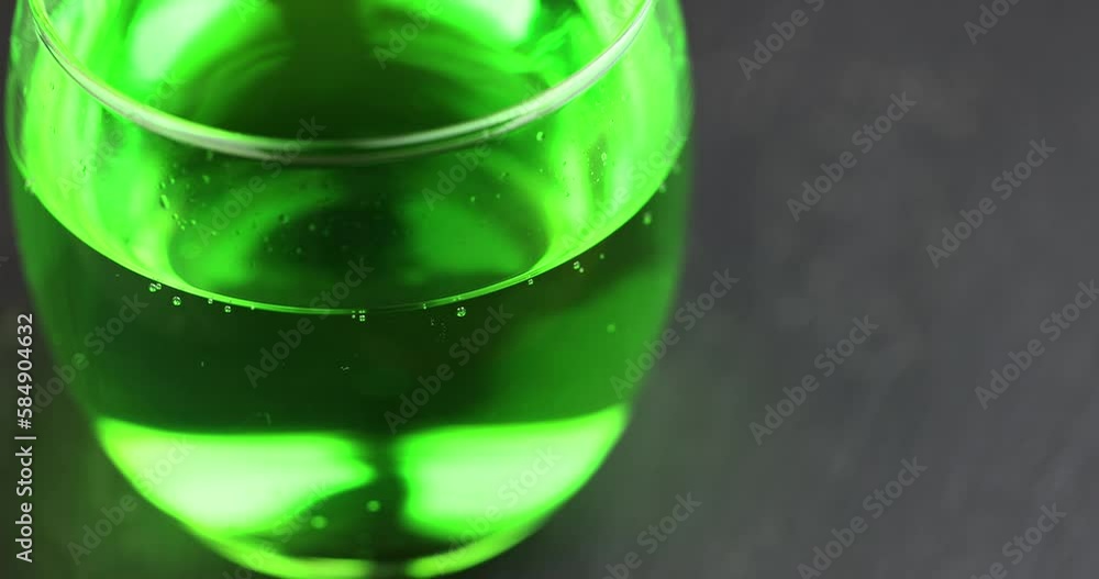 Green carbonated drink with gas on the table, green carbonated drink in a glass transparent glass Green carbonated drink with gas on the table, green carbonated drink in a glass transparent glass