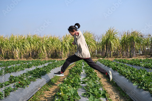 Asian girl tiao yue in strawberry field photo