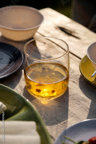 Closeup of scented herbal tea drink on picnic table outdoors