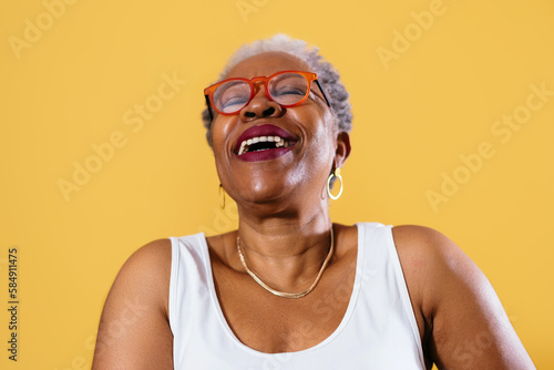 Positive gray haired woman in studio photo