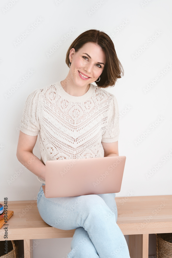 Young woman working from home with her laptop. Young woman working from home with her laptop.