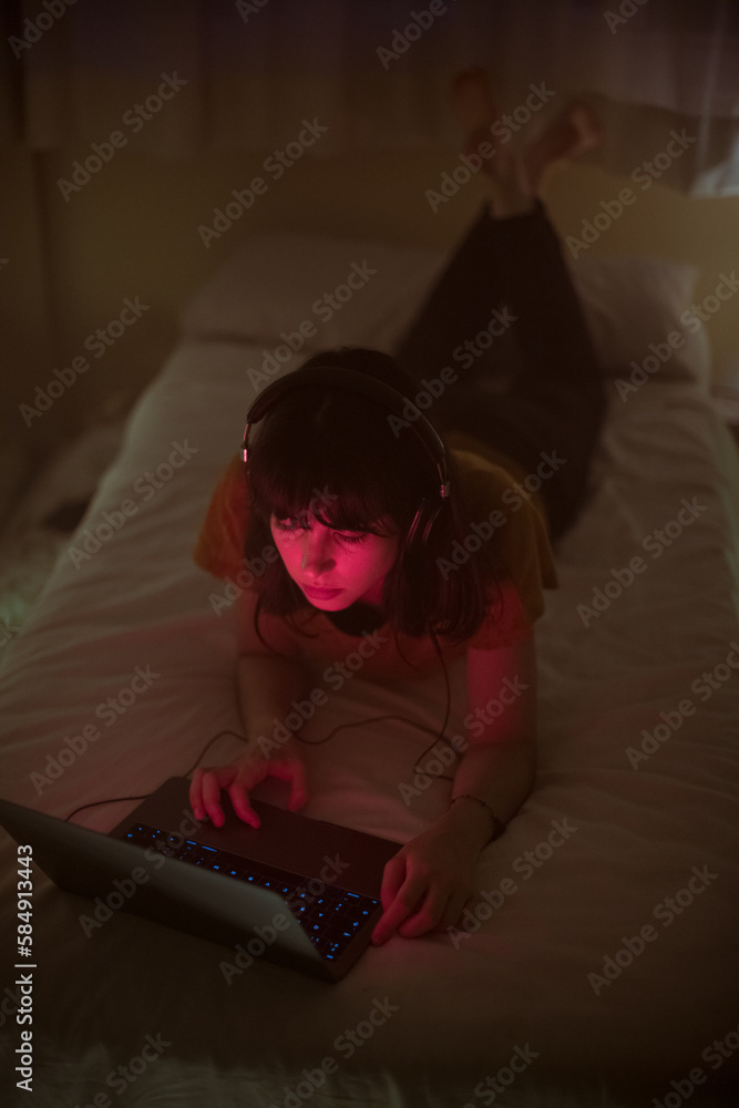 Relaxed woman using laptop on bed Relaxed woman using laptop on bed
