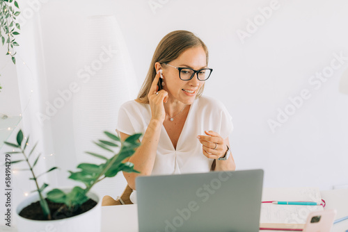 Female online tutor on a teleconference photo