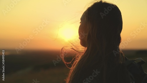 girl tousled hair wind. silhouette girl. man journey sunset. look into distance. female travel picnic. beautiful girl against backdrop heavenly sunset evening. free feeling life. woman hair wind