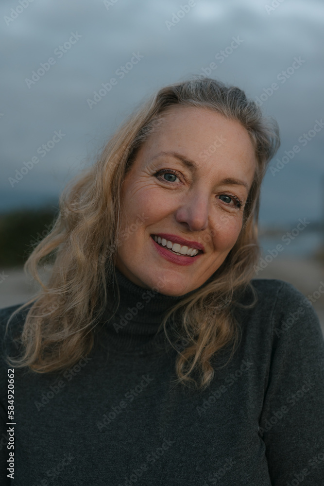 Healthy mature woman looking at the camera for sunset portrait. Healthy mature woman looking at the camera for sunset portrait.