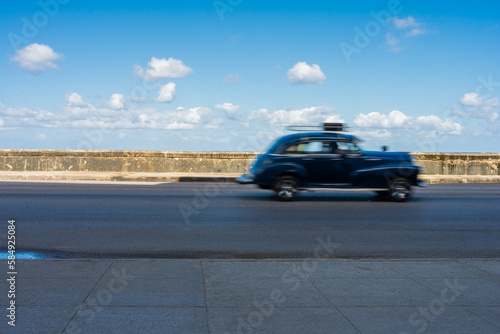 Antique Black Car Driving On A Malecon Highway