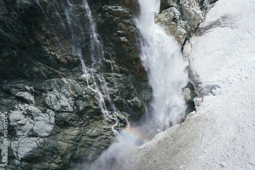 Rainbow. waterfall and glacier photo
