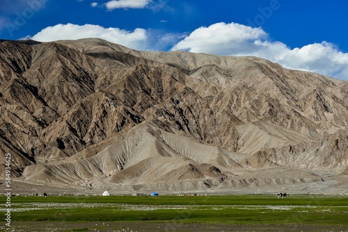 Fotografie Alar National Wetland Park is surrounded by high mountains