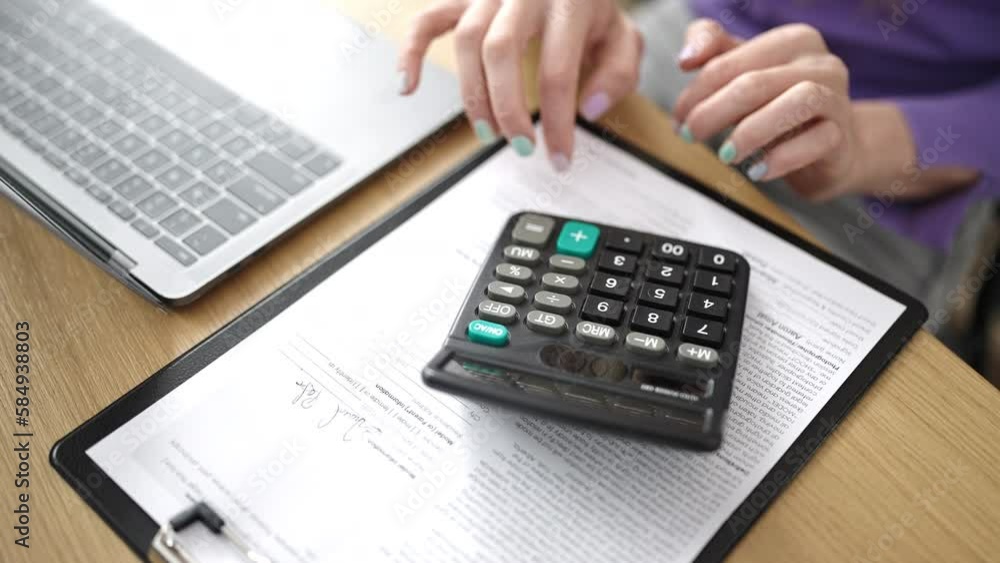 Young blonde woman business worker using laptop and calculator at office Young blonde woman business worker using laptop and calculator at office