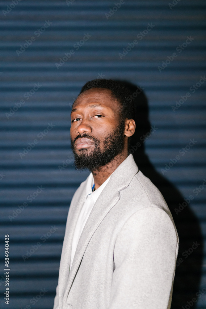 Confident bearded black man against striped wall Confident bearded black man against striped wall
