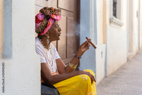 Black Woman Smoking A Cigar In Cuba.