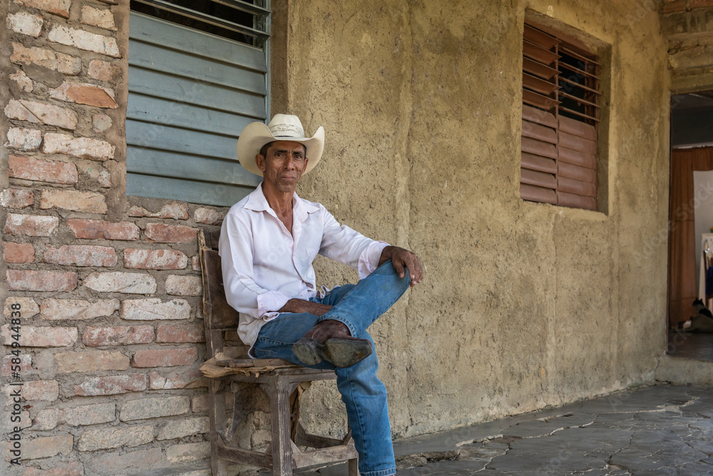 Smiling Farmer Sitting On A Chair Smiling Farmer Sitting On A Chair