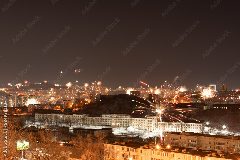 Fireworks in the city at night during New Year or other holidays celebration. Soft focus background