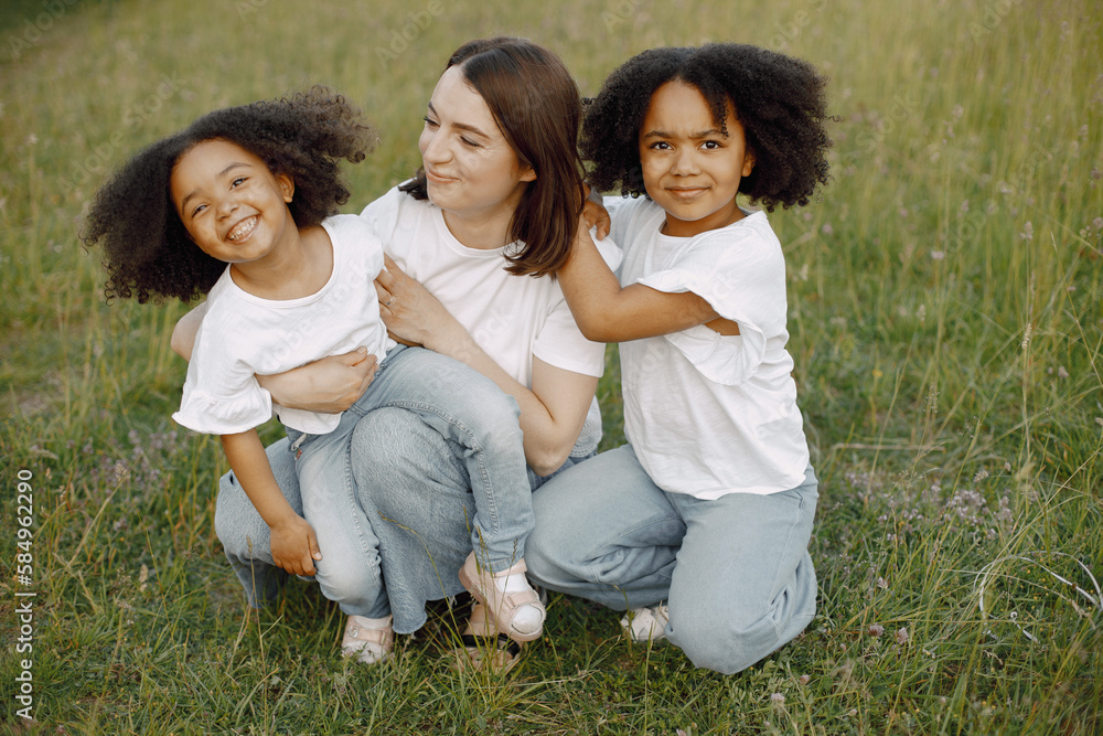 Caucasian mother embracing her mixed race daughters Caucasian mother embracing her mixed race daughters