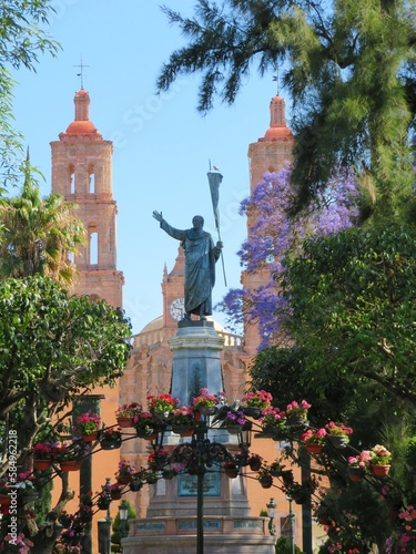 statue of Miguel Hidalgo with a cathedral, Dolores Hidalgo, Mexico photo